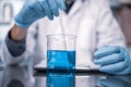 In a Modern Laboratory Research Scientist Conducts Experiments by Synthesising Compounds