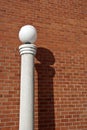 Modern lamp on column near red brick wall Royalty Free Stock Photo