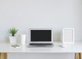 Modern lap top template mock up on white desk with blank screen