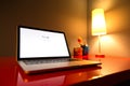 Modern laptop closeup on red modern desk