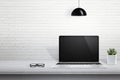 Modern laptop computer on desk with blank screen for mockup