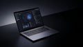 Modern laptop computer displaying data charts and graphs on its screen in a dark, moody studio setting Royalty Free Stock Photo