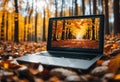 Modern laptop computer resting on a wooden ground adorned with fallen leaves, AI-generated.