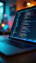 Modern laptop displaying code. Tech workspace in background. Close-up view. Programmer working late. Coding in progress. Software