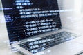 A laptop displaying HTML coding language on the screen with graphical user interface elements superimposed Royalty Free Stock Photo
