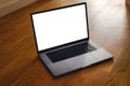 Modern laptop with empty display on hardwood floor, template for digital content, technology or remote work concept Royalty Free Stock Photo