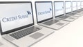 Modern laptops with Credit Suisse Group logo. Computer technology conceptual editorial 3D rendering