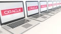 Modern laptops with Oracle Corporation logo. Computer technology conceptual editorial 3D rendering