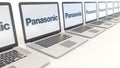 Modern laptops with Panasonic Corporation logo. Computer technology conceptual editorial 4K clip, seamless loop