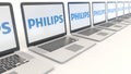 Modern laptops with Philips logo. Computer technology conceptual editorial 4K clip, seamless loop