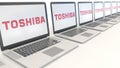 Modern laptops with Toshiba Corporation logo. Computer technology conceptual editorial 3D rendering