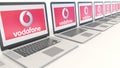 Modern laptops with Vodafone logo. Computer technology conceptual editorial 3D rendering