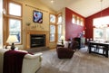 Modern large open living room with red wall.