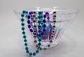 Modern lead crystal glass bowl with colorful mardi gras beads Royalty Free Stock Photo