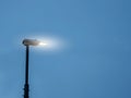 Modern LED energy saving lamp in a street on a metal pole against blue color sky. Illuminating streets concept. Technology and Royalty Free Stock Photo