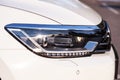 Modern LED headlight on a white car, close up Royalty Free Stock Photo