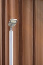 Modern LED solar power street light post against wooden trellis wall outside of vintage building Royalty Free Stock Photo