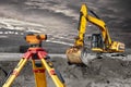 Modern level for geodesy at a construction site. Surveyors ensure precise measurements before undertaking large construction Royalty Free Stock Photo
