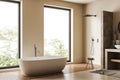 Modern light bathroom interior with bathtub and douche, panoramic window