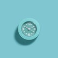 Modern light blue alarm clock on blue background