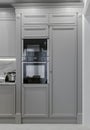 Modern light classical kitchen interior with combination oven, microwave and fridge