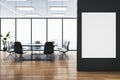 Modern light meeting room interior with wooden flooring, empty white mock up banner on wall, furniture and panoramic window with Royalty Free Stock Photo