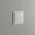A modern light switch is installed on a smooth, gray wall. It features a minimalist design Royalty Free Stock Photo