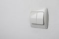 Modern light switch on white wall. Space for text Royalty Free Stock Photo