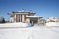 Modern ligth cottage with iron gates at frosty and Royalty Free Stock Photo