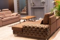 Modern living room with brown tufted leather sectional sofa Royalty Free Stock Photo