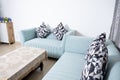 Modern living room and close up of green sofa with linen cushions Royalty Free Stock Photo