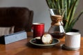 A modern living room coffee table with a coffee cup, book, tablet, and a muffin on it. Royalty Free Stock Photo