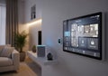 Modern living room featuring a smart home interface on a wall-mounted touchscreen displaying Royalty Free Stock Photo