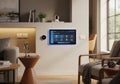 Modern living room featuring smart home technology. A wall-mounted touch screen control panel Royalty Free Stock Photo