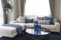 Modern living room interior with comfortable white couch and blue color pillows. Royalty Free Stock Photo