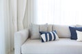 Modern living room interior with comfortable white couch and blue color pillows. Royalty Free Stock Photo