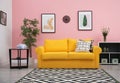 Modern living room interior with comfortable yellow sofa Royalty Free Stock Photo