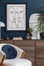 Modern living room interior composition with mock up poster frame, armchair, wooden commode and modern accessories. Blue wall. Royalty Free Stock Photo