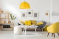 Modern living room interior design with yellow details. Yellow armchair in a bright cozy stylish living room. Apartment desing in Royalty Free Stock Photo