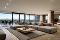 Modern living room interior with large sofa, coffee table, and panoramic view of mountains through floor-to-ceiling windows Royalty Free Stock Photo