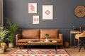 Modern living room interior with mock up poster frame, brown sofa, wooden coffee table, patterned rug, round clock, plants, beige