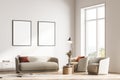 Modern living room interior with two armchairs, sofa and commode, lamp. Two mock up framed posters on white wall. Reading and Royalty Free Stock Photo