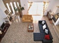Modern living room with tiled floor, fireplace and sofas, seen from above Royalty Free Stock Photo