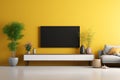 In a modern living room, a TV wall console, table, and plants adorn a radiant yellow wall