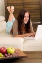 Modern living room woman lying sofa laptop Royalty Free Stock Photo