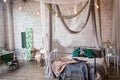 Modern loft bedroom with high ceiling, brick wall, wood floor, wooden cabinet, design accessories in the steel stack