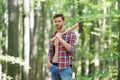 Modern logger. ranch man carry axe. sexy guy wear unbuttoned shirt in forest. male power and energy. firewood at the