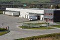 Modern logistics center, white van and trailers standingon ramp Royalty Free Stock Photo