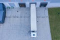Modern logistics center, white van and trailers standingon ramp. Aerial View Royalty Free Stock Photo