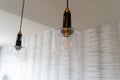 Modern looking kitchen hanging light fixtures inside a house features an exposed lightbulb Royalty Free Stock Photo